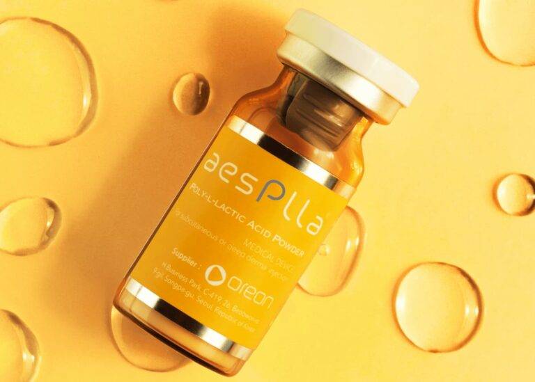 Treatments 9 AesPlla vial on a golden background with water droplets
